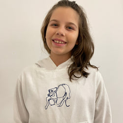 Little gril wearing her custom embroidered hoodie with line art of her holding her little dog.