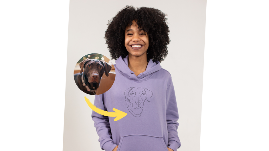 Joyful black girl wearing a custom embroidered hoodie with line art made from a photo of her dog.