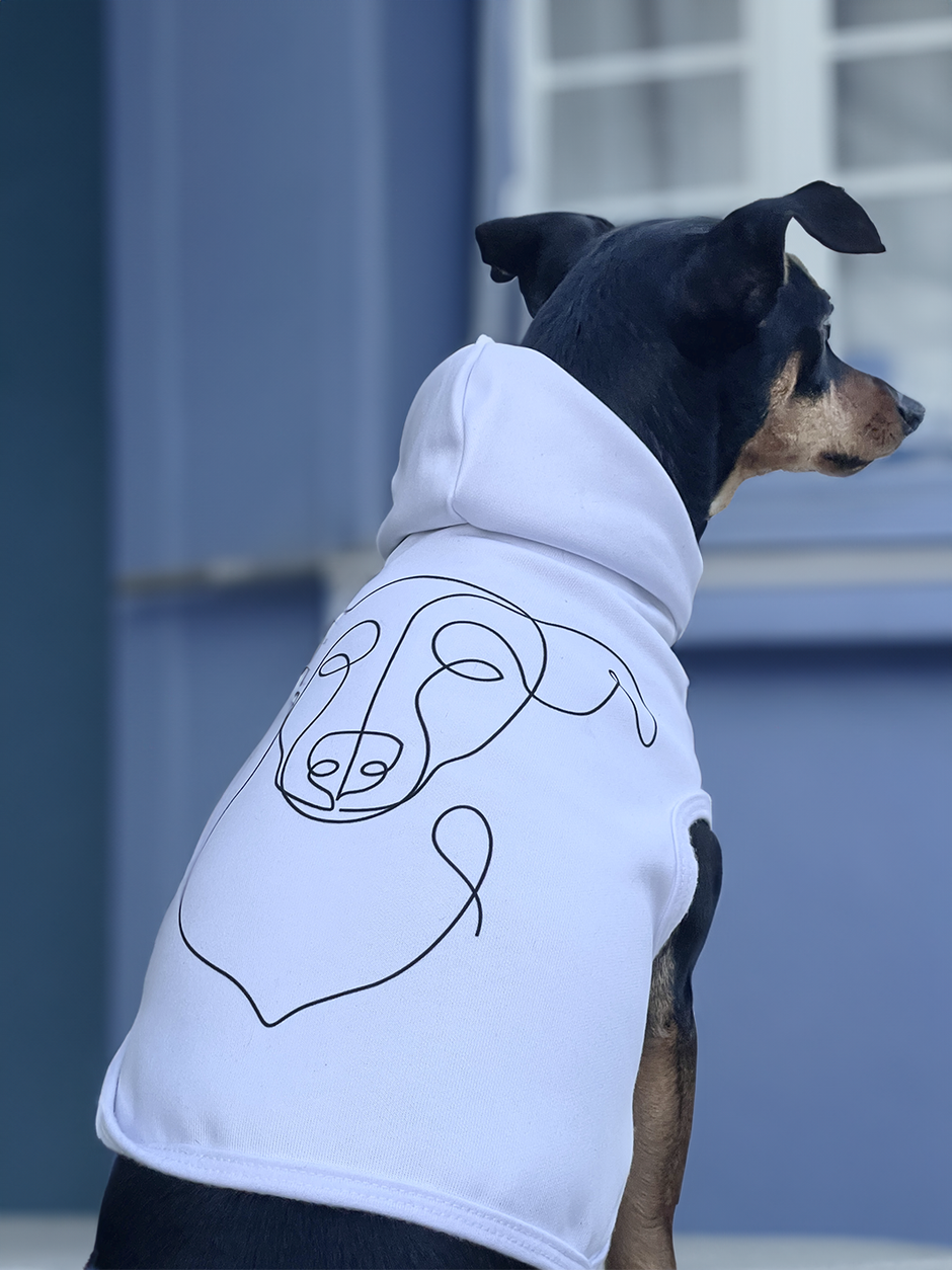 Dog wearing his custom hoodie. The hoodie has line art of the dog's face on the back.