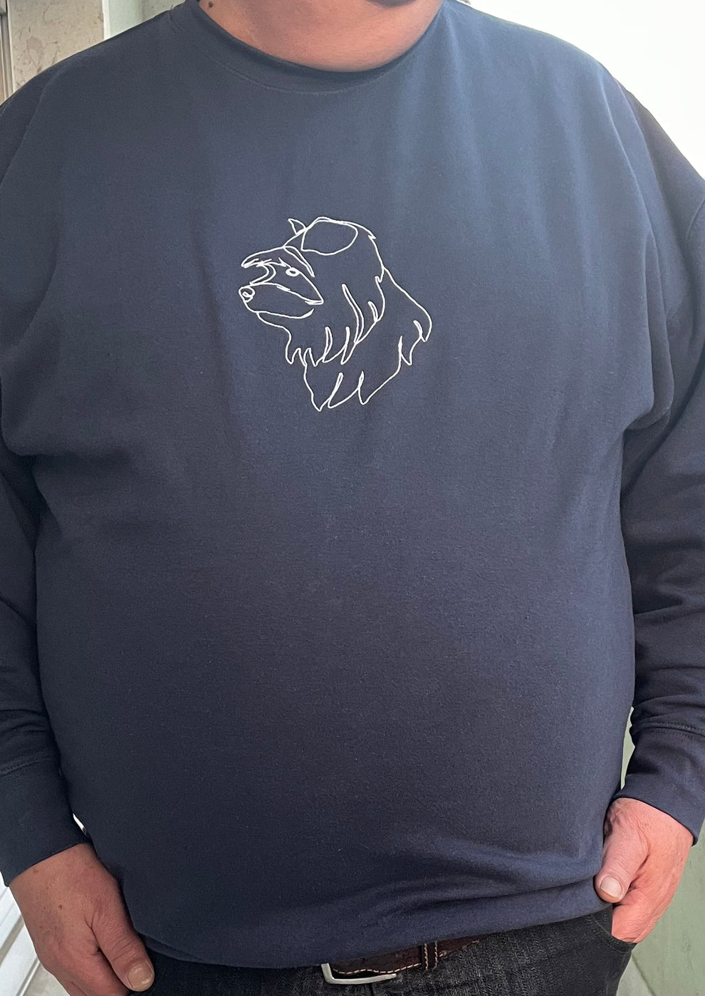 Client wearing his custom embroidered sweatshirt with line art of his dog portrait (Yorkshire Terrier).