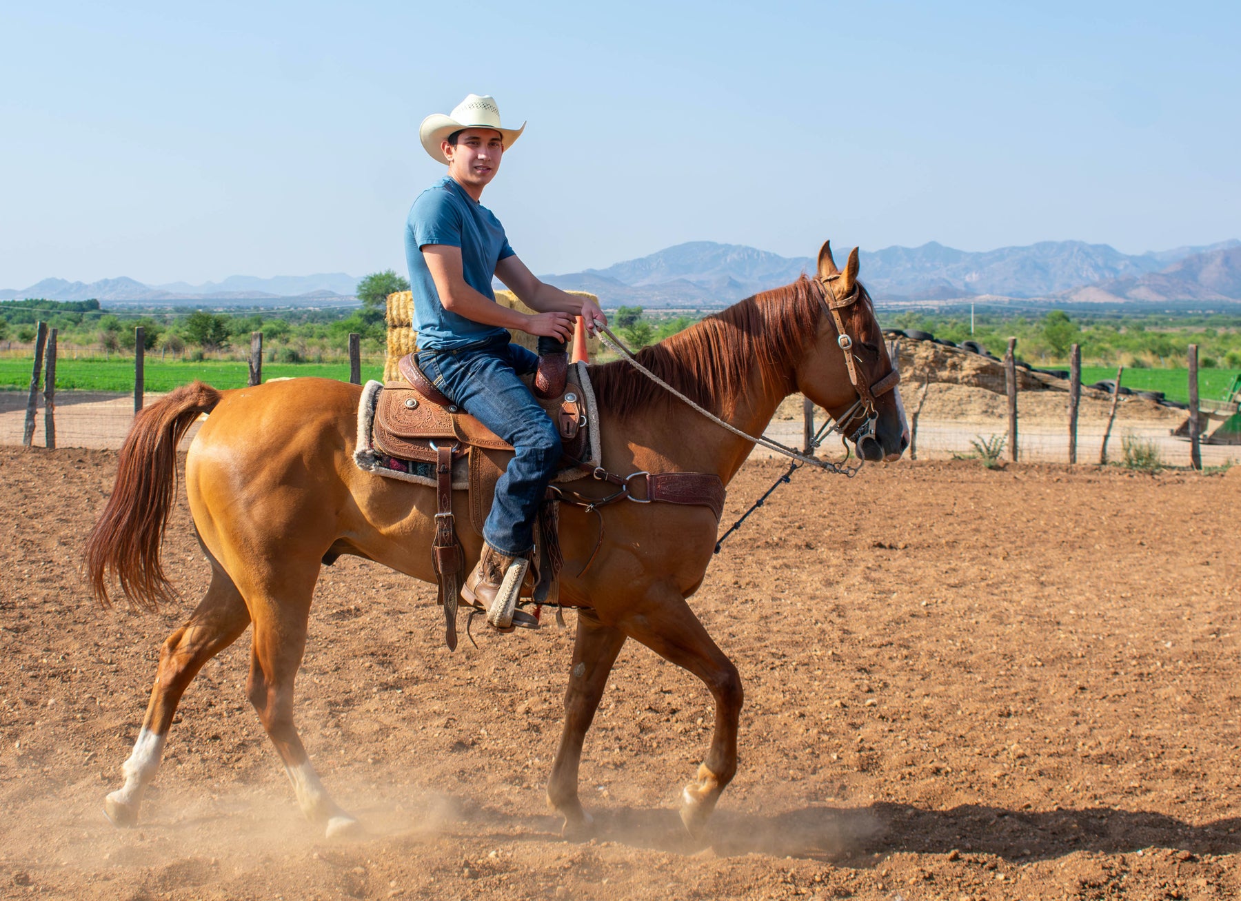 Photo of a cowboy riding his horse.